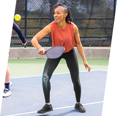 Girl holding pickleball paddle